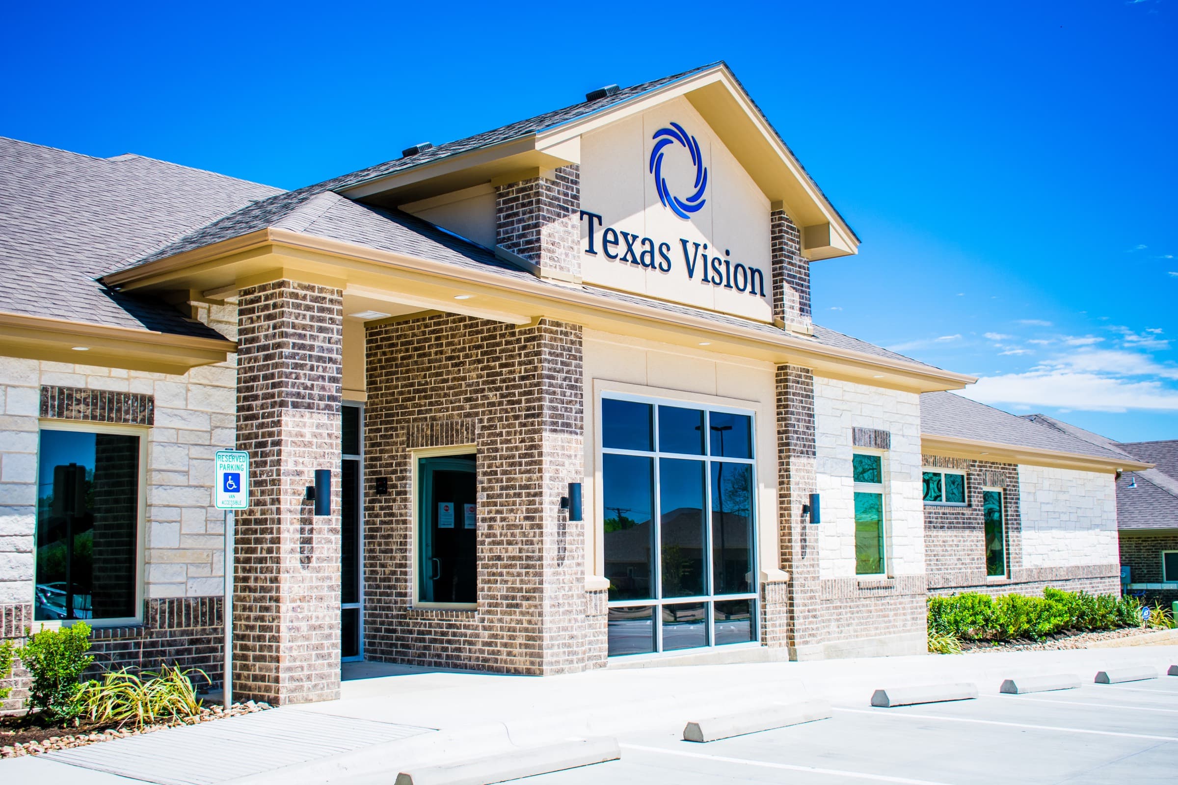 The Texas Vision Temple office, a stone-and-brick building under a Central Texas sky
