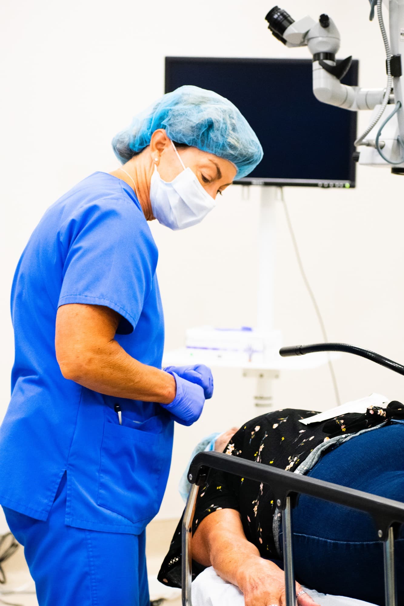 A gowned and gloved Texas Vision surgeon during a procedure