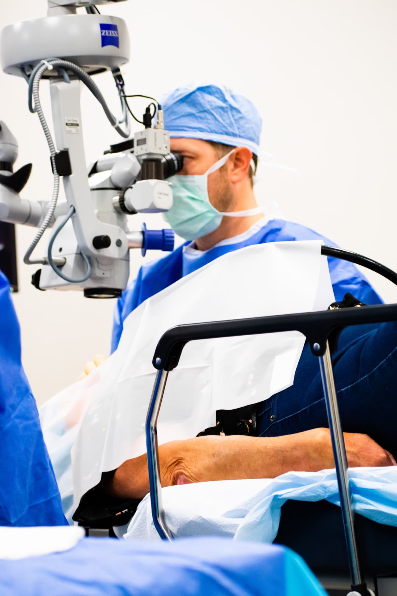 A surgeon at the microscope in the Texas Vision surgical suite